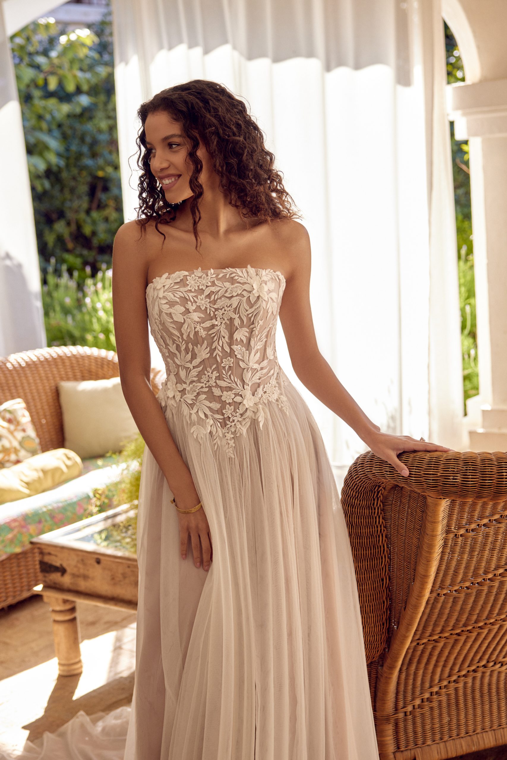 Lillian West 66430 wedding dress straight across strapless neckline lace bodice basque waist tulle a-line skirt lace up side detail