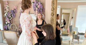 Bride having her wedding dress fitted during an alterations appointment at The Bridal Collection in Denver.