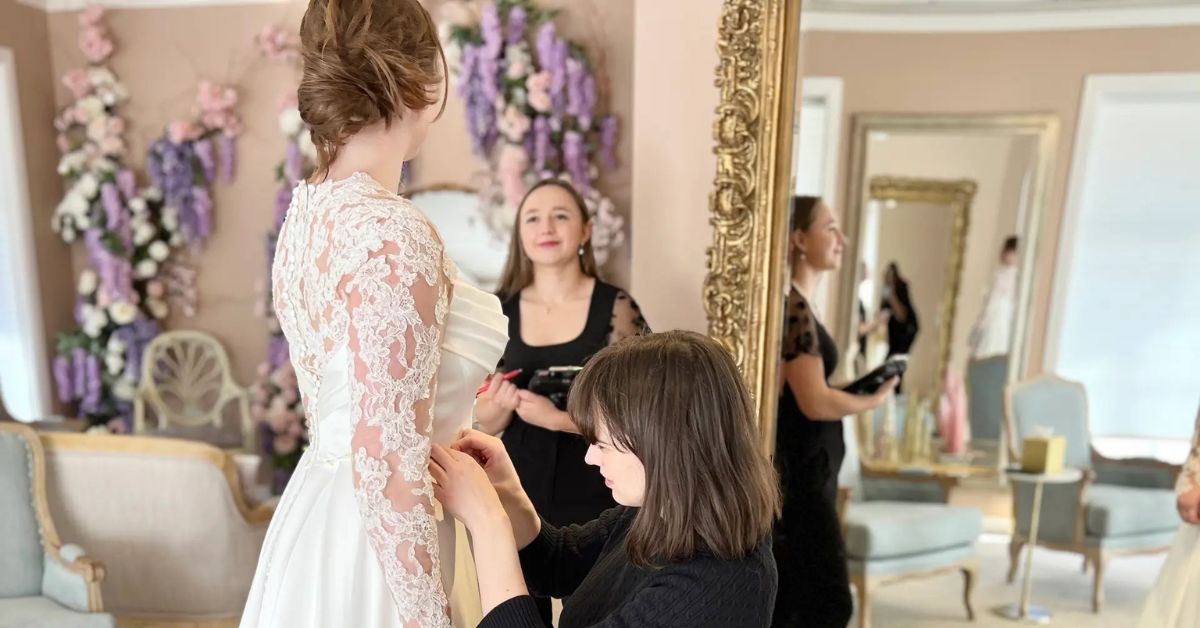 Bride having her wedding dress fitted during an alterations appointment at The Bridal Collection in Denver.