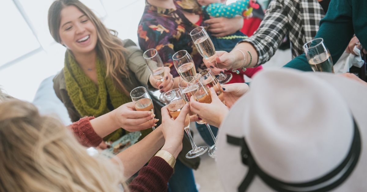 bride and loved ones having a champagne toast at her wedding dress shopping appointment, how to elevate your wedding dress shopping appointment